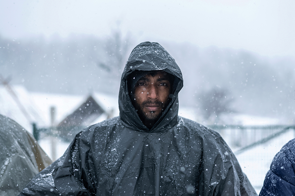 Lipa, Bosnia and Herzegovina, 2021-01-31. A Pakistani migrant portrayed during the daily food distribution, inside the Temporary Reception Centre of Lipa. Photograph by Matteo Placucci